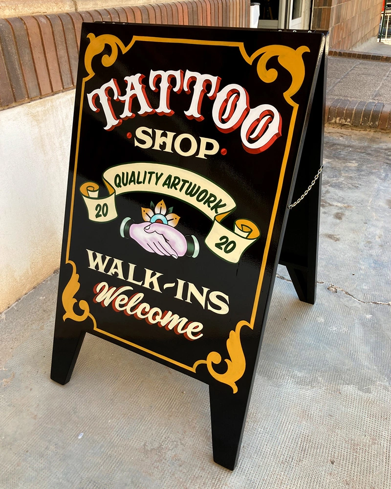 chalkboard-easel-sign-tattoo-studio-by-Cristian-Roldan-art